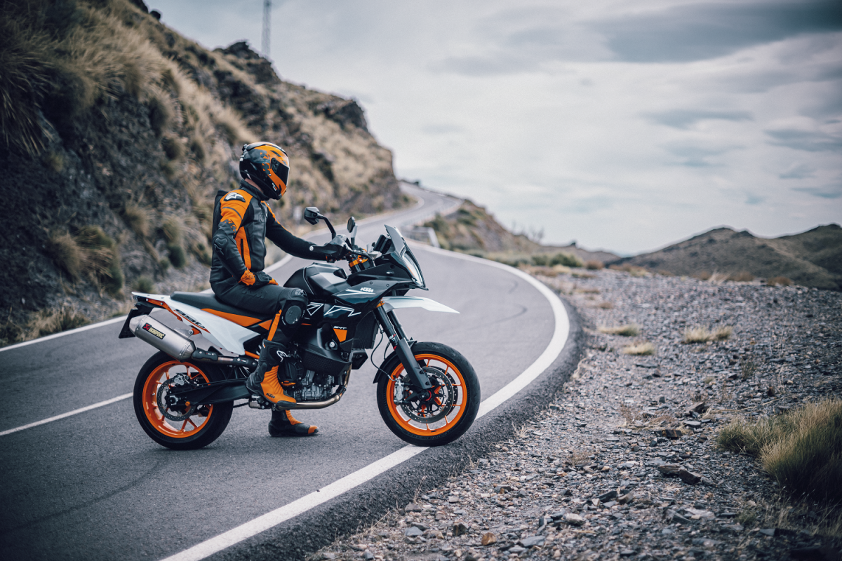 The new launched KTM 890 SMT stood still on the road overlooking hilly terrain
