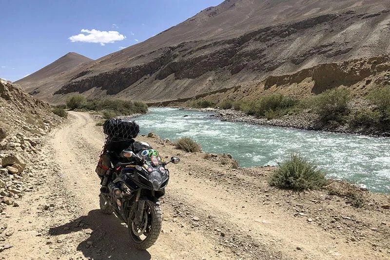 GSXR-600 with panniers and storage mods, Travelling through India, next to a river